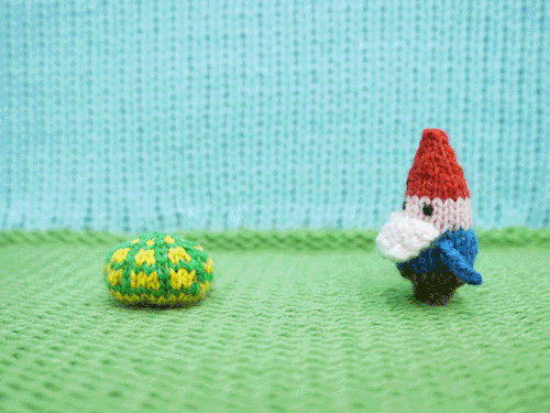 Garden gnome reaching out to a turtle, who comes out of its shell